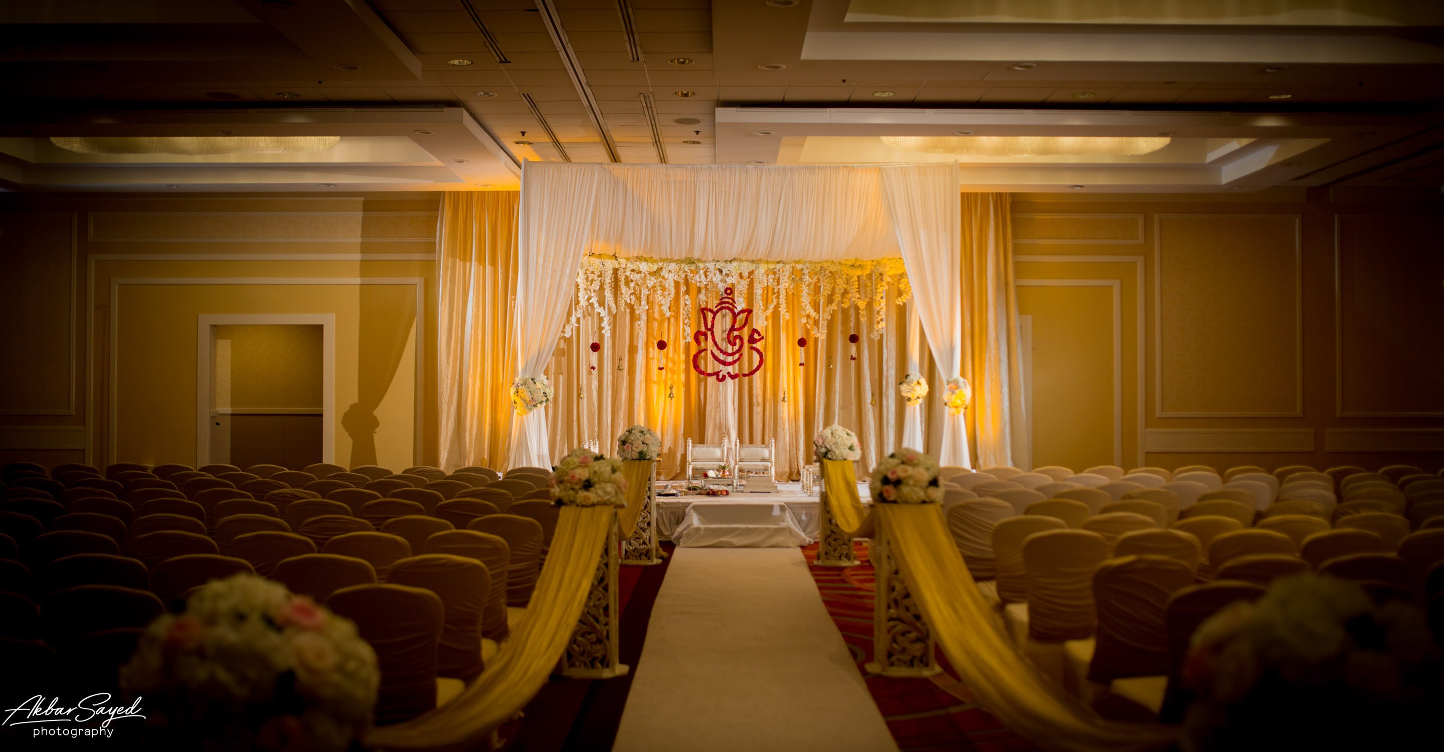 A photo of a mandap created by l'ambiance weddings for a hindu wedding at the bwi marriott in baltimore, maryland.