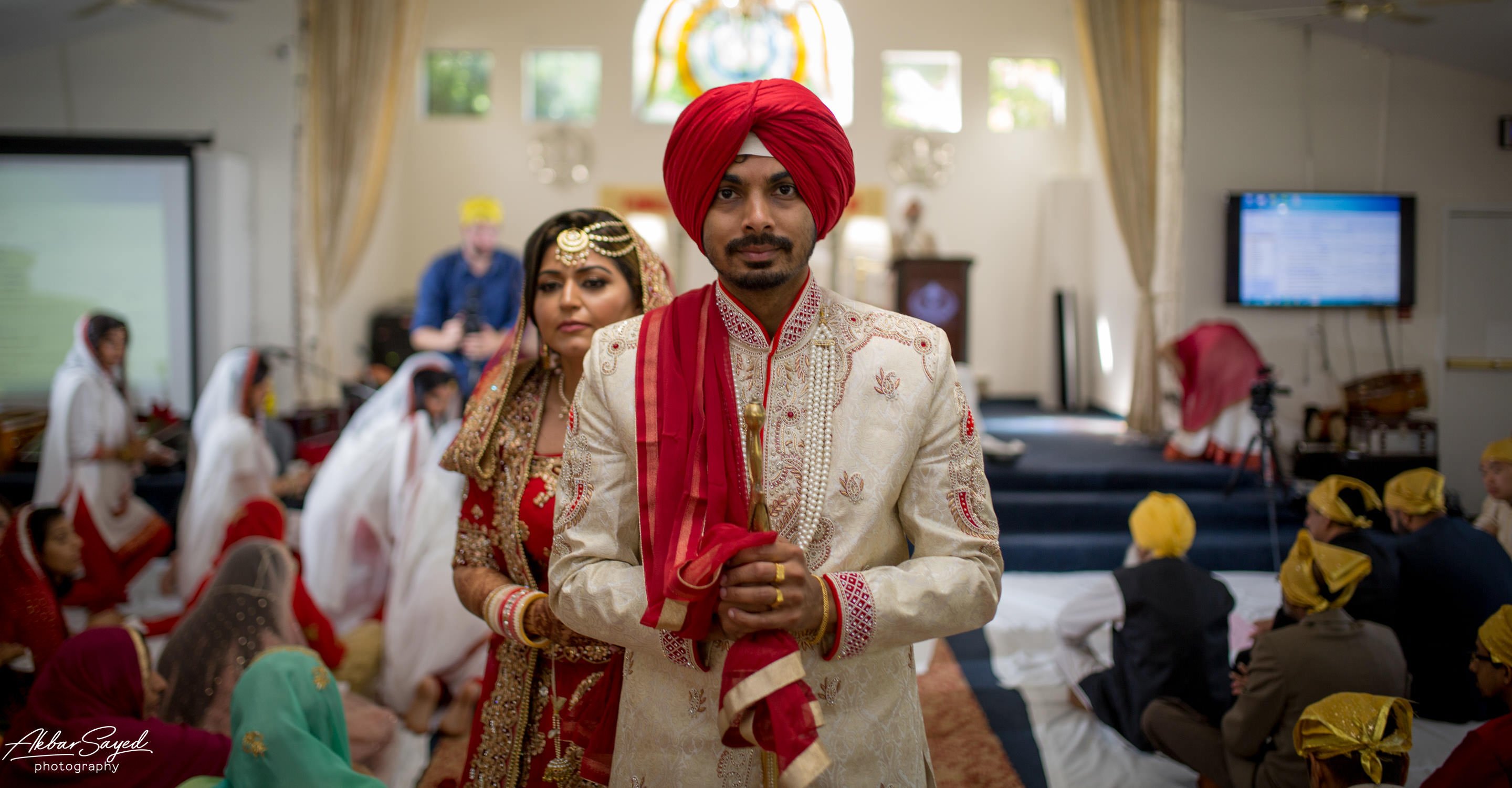 A photo of a sikh couple leaving the wedding hall immediately after getting married at the guru nanak foundation of america in silver spring, maryland.